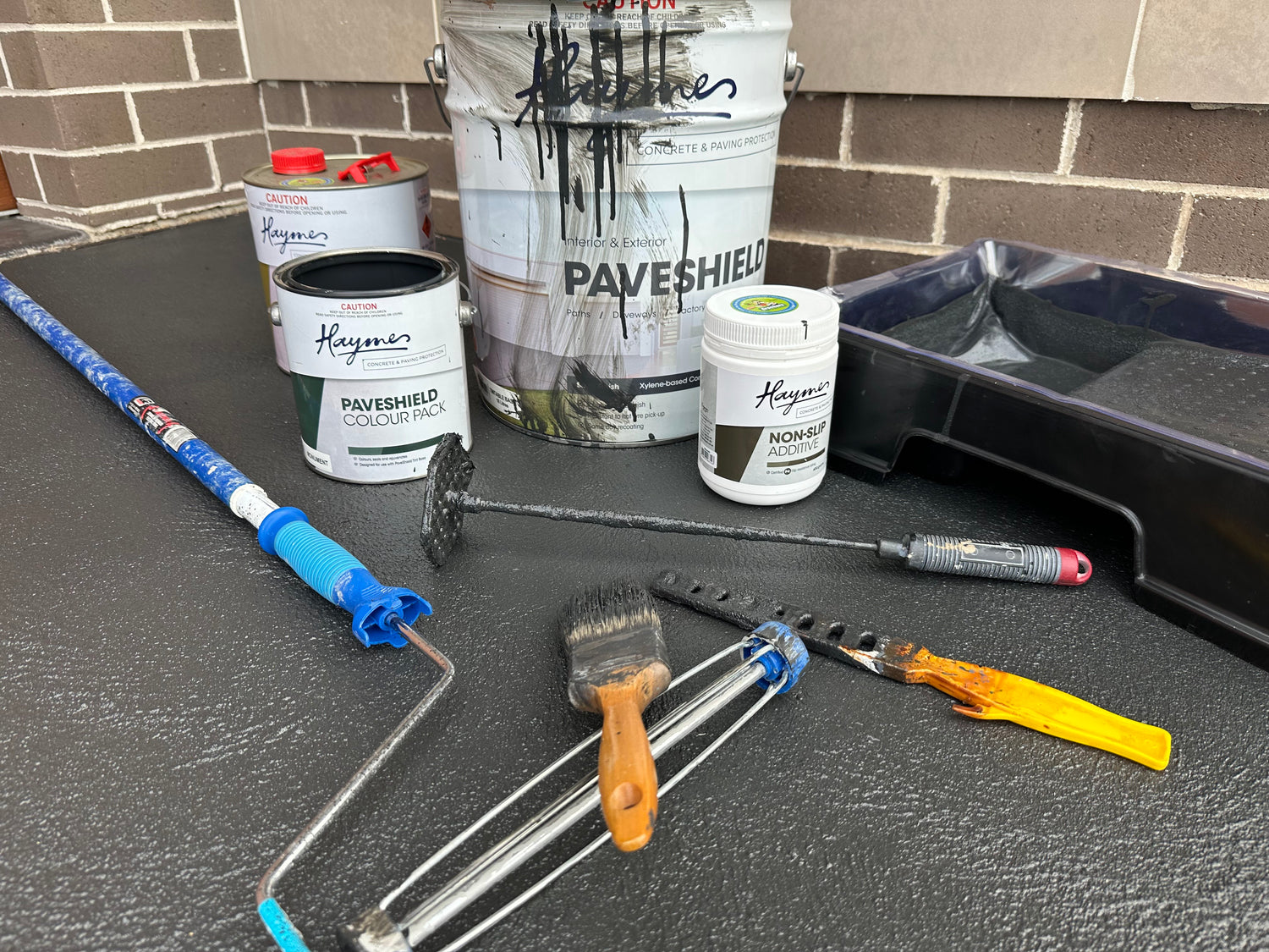 Products needed to paint a concrete driveway in a Monument coloured sealer call Haymes Paveshield